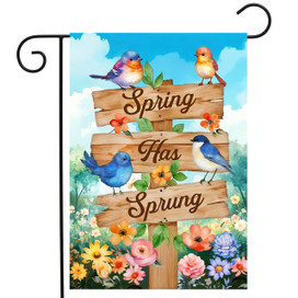Spring Has Sprung Sign Garden Flag with colorful flowers and birds on wooden sign post outdoors.