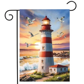 Lighthouse At Sunset Garden Flag with red and white stripes and seagulls in flight at sunset.