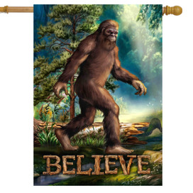Believe Bigfoot House Flag, brown Sasquatch walking in forest with trees and text saying Believe.