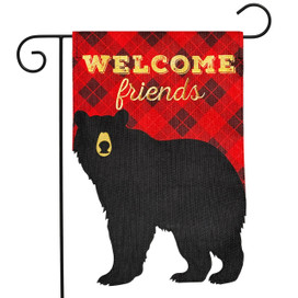 Black bear on red burlap garden flag with "Welcome Friends" text, findme, hanging on metal stand.
