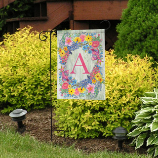 Briarwood Lane Spring Monogram Letter A garden flag with colorful flower wreath design outdoors.