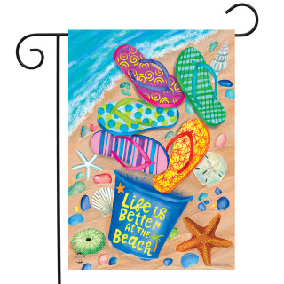 Briarwood Lane Better At The Beach garden flag with colorful flip flops on sandy ocean shore.