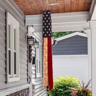 Briarwood Lane USA Tea Stained Windsock hanging from a house porch, American flag design.