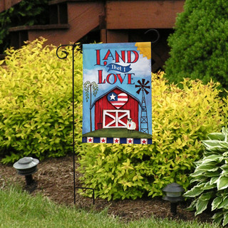 Briarwood Lane patriotic garden flag with red barn, stars, stripes, and "Land That I Love" text.