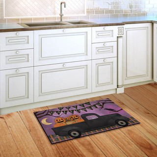 Briarwood Lane Halloween Truck Primitive Doormat with pumpkin jack-o-lantern on purple background on wooden floor.
