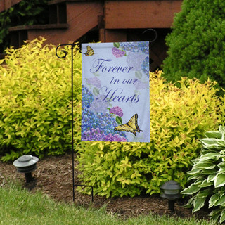 Briarwood Lane Forever In Our Hearts garden flag with colorful butterflies and flowers on display outdoors.