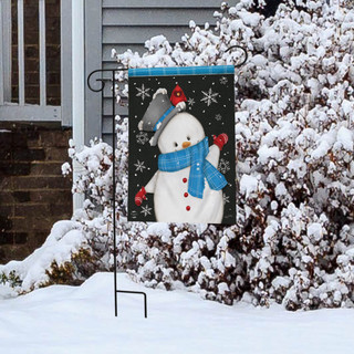 Briarwood Lane Jolly Winter Snowman Garden Flag with snowflake design on a snowy porch display stand.