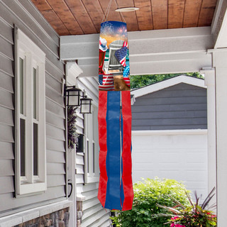 Briarwood Lane Fourth of July windsock with fireworks and nautical theme hanging from a porch.