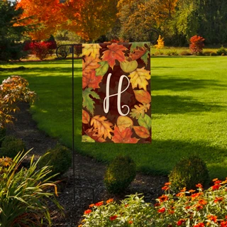 Briarwood Lane Fall Leaves Monogram Letter H garden flag with colorful foliage on a small yard display.