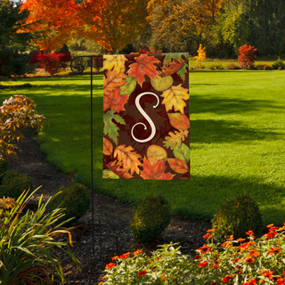 Briarwood Lane Fall Leaves Monogram Letter S garden flag with colorful foliage on a yard lawn.