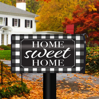 Briarwood Lane Home Sweet Home black and white checkers spring mailbox cover on a yard display.