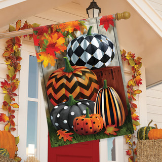 Briarwood Lane autumn house flag with colorful, printed pumpkins and stripes on a porch.