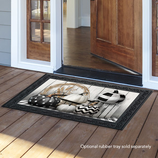 Briarwood Lane Black White Pumpkins Fall Doormat on wooden porch in front of open doorway.
