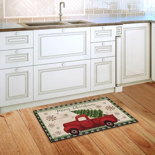 Briarwood Lane Merry Christmas pickup truck doormat on a kitchen floor with a red truck design.