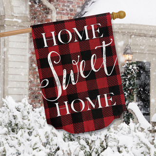 Red and black checkered flag with "Home Sweet Home" on a snowy porch display.