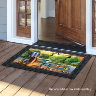 Briarwood Lane Lakeside Escape Summer Doormat on wooden floor by open door with lake scene design.