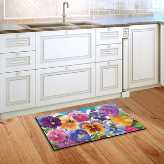 Briarwood Lane Pansies Spring Doormat on wooden floor beside white kitchen cabinets and sink area.