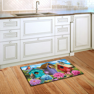 Briarwood Lane Colorful Birdhouses Spring Doormat on wooden floor beside kitchen sink and white cabinets.