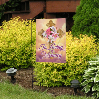 Briarwood Lane In Loving Memory Cross Bereavement Garden Flag on a decorative yard display stand outside.