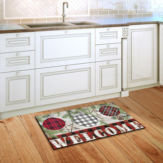 Briarwood Lane Christmas doormat with colorful, cheery ornaments and welcome message on wooden floor.