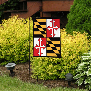 Briarwood Lane Maryland garden flag displayed on a yard stake near a vibrant flowerbed outdoors.