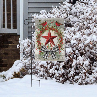 Briarwood Lane Berry Wreath Barnstar Winter Garden Flag on a snowy lawn display stand outside home.