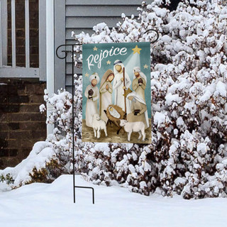 Briarwood Lane Rejoice Nativity Christmas Garden Flag on a snowy lawn display near a house.