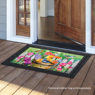 Briarwood Lane Birds and Blooms doormat with colorful floral and bird design on wooden porch.