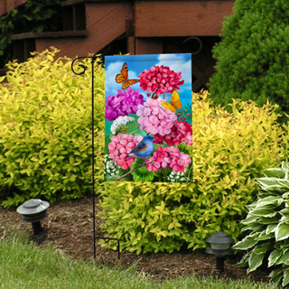 Briarwood Lane garden flag with colorful flowers, butterflies, and blue jay on a decorative yard display.