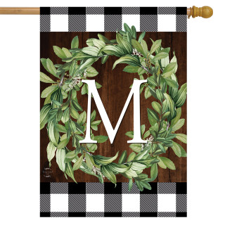 Briarwood Lane monogrammed house flag with green wreath on plaid background, colorful decorative seasonal display.