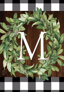 Briarwood Lane monogrammed wreath with greenery and checkered border on a wooden background.