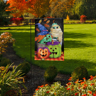 Briarwood Lane Costumed Pumpkins Garden Flag with colorful Halloween characters on a garden lawn display.