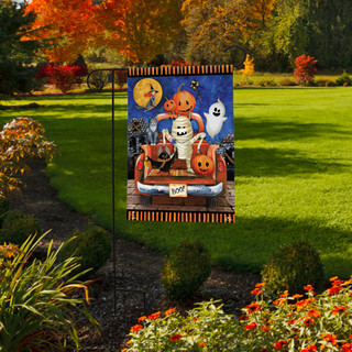 Briarwood Lane Haunted Pickup Garden Flag with Halloween design on a lawn garden display.