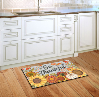 Briarwood Lane Be Thankful Flowers Doormat with sunflowers and pumpkins on a kitchen floor.