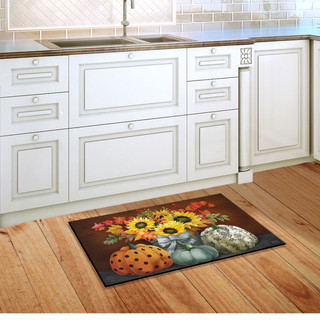 Briarwood Lane Patterned Pumpkins and Sunflowers doormat on wooden floor in front of white kitchen cabinets.