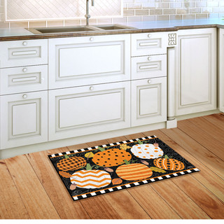 Briarwood Lane Fall Celebration Pumpkins Doormat with orange, white, and black pumpkins on wooden floor.