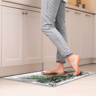 Briarwood Lane Christmas on the Farm Comfort Mat under bare feet in a kitchen setting.