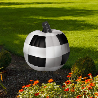 Black and white pumpkin yard art by Briarwood Lane, checkered design on metal outdoor decoration.