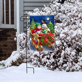 Briarwood Lane Dashing Through the Snow garden flag with snowmen on a sleigh at night.