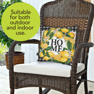 Briarwood Lane Lemon Wreath Summer Pillow on a wicker chair with white cushion and seat.