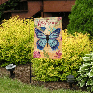 Briarwood Lane Beautiful Butterfly Garden Flag with blue butterfly and welcome text on decorative stand outdoors.