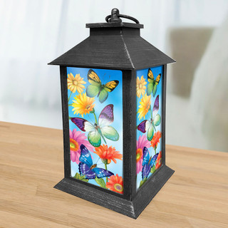Briarwood Lane Fluttering Butterflies Lantern with colorful butterflies and flowers on a black metal frame.