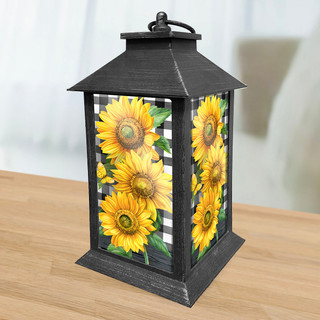 Briarwood Lane black metal lantern with checkered sunflowers design on a wooden surface.