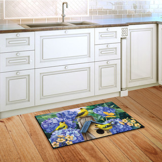 Briarwood Lane Goldfinches and Hydrangea doormat with colorful birds and flowers on kitchen floor.