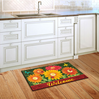 Briarwood Lane Colorful Daisies doormat on wooden floor in front of white kitchen cabinets.