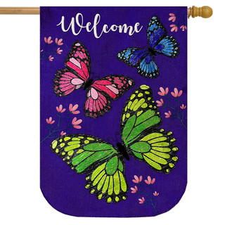 Briarwood Lane purple burlap house flag with colorful butterflies and welcome text on a garden pole.