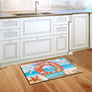 Briarwood Lane Coral Wreath Doormat on wooden floor in front of white kitchen sink cabinets.
