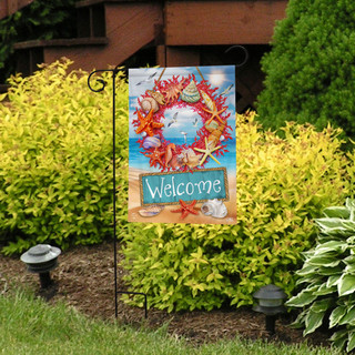 Briarwood Lane Coral Wreath Garden Flag with colorful coral and seashells welcomes guests outdoors.
