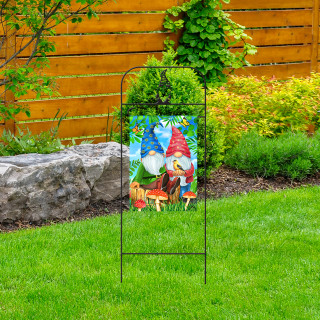 Briarwood Lane wrought iron gnome garden flag arbor with colorful garden gnome design standing on grass.