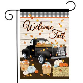 Black truck garden flag with Welcome Fall text, pumpkins, and leaves on a wood background.
